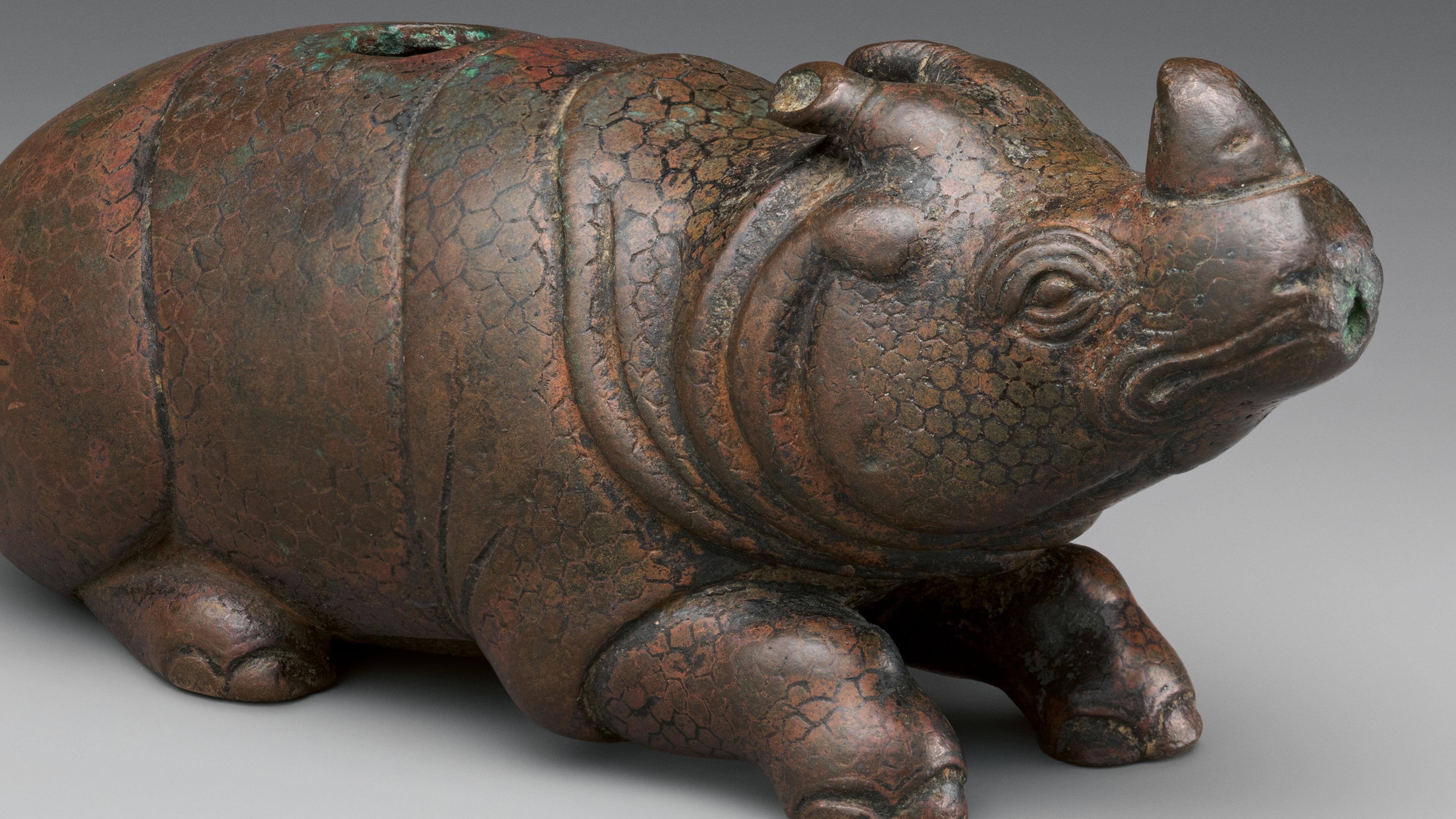 Water dropper in the shape of a rhinoceros.